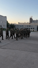 Group in green sweatsuits, children playing observed in Марковский