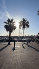 Bubble performer entertains children at Barcelona's Port Vell harbor