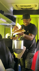 Food vendor sells fried plantain sandwiches on Venezuelan bus