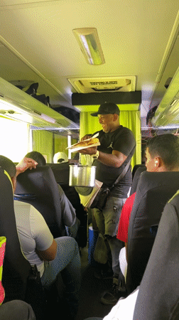 Food vendor sells fried plantain sandwiches on Venezuelan bus