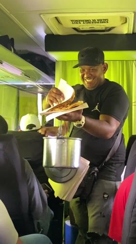 Food vendor sells fried plantain sandwiches on Venezuelan bus