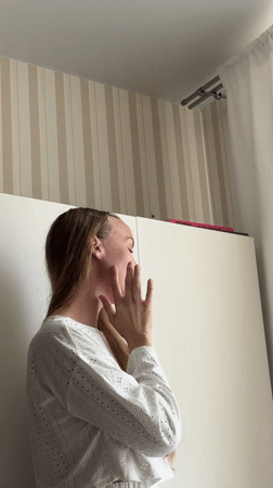 Woman in white shirt observed near striped wall in Sirius