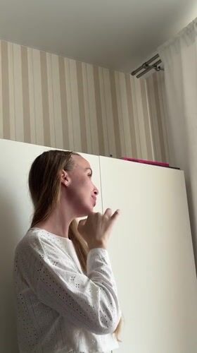 Woman in white shirt observed near striped wall in Sirius