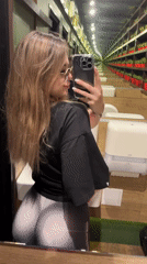 Person records multiple mirror selfies in indoor location