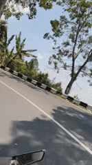 Riding through Nglebak's rural roads past stalls and greenery