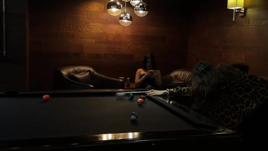 Pool game in a moody Mexico City billiards room