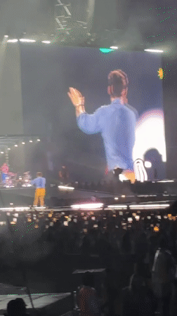 Live concert in London, performer on stage and big screen