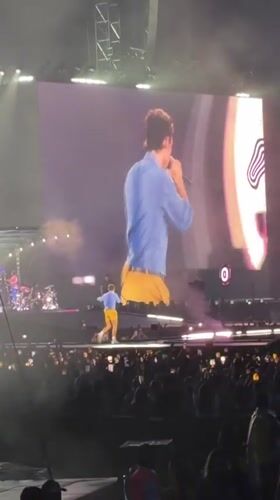 Live concert in London, performer on stage and big screen