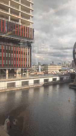 Train ride past London's docklands skyline and waterways