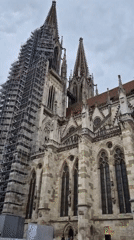 Renovation scaffolding visible on Regensburg Cathedral amid tourist activity