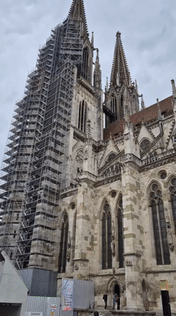 Renovation scaffolding visible on Regensburg Cathedral amid tourist activity