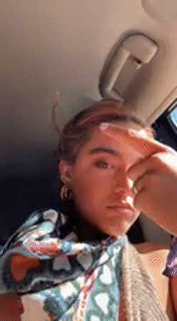 Woman with pink-streaked hair filmed in car in Coachella