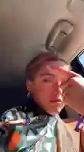 Woman with pink-streaked hair filmed in car in Coachella