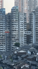Red gondola travels above traditional buildings in Nan'an District
