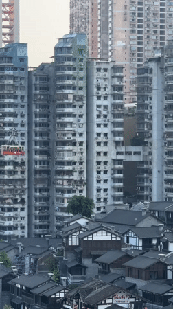Red gondola travels above traditional buildings in Nan'an District