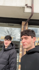 Two men film selfies on Bansko streets