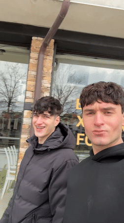 Two men film selfies on Bansko streets