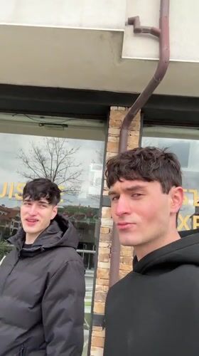 Two men film selfies on Bansko streets