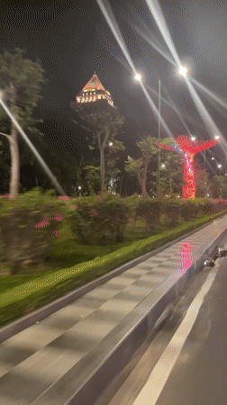 Vehicle captures illuminated decorative installations in nighttime Phan Thiet