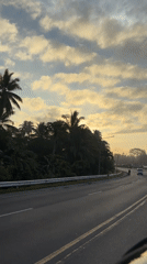 Motorcyclist crosses bridge at sunset in Tagum, Philippines