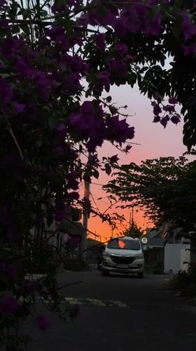 Bougainvillea and a vivid sunset along a Kuta Selatan street