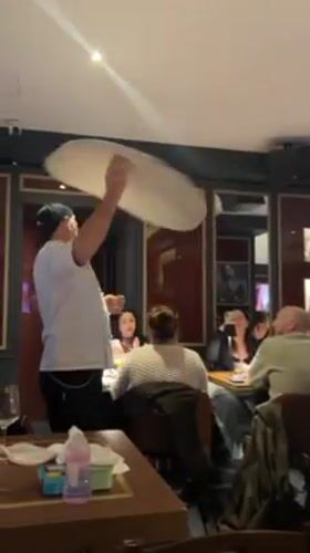 Chef performs traditional pizza dough spinning demonstration in Rome