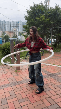 Hula hooping and bar work at a Busan park