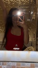 Bathroom selfie session in a brown-tiled Ufa apartment