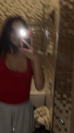 Bathroom selfie session in a brown-tiled Ufa apartment