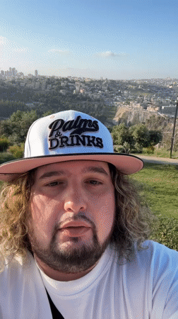 Man in branded cap photographed in Jerusalem