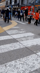 Pedestrians cross marked crosswalk in Ushuaia, Argentina