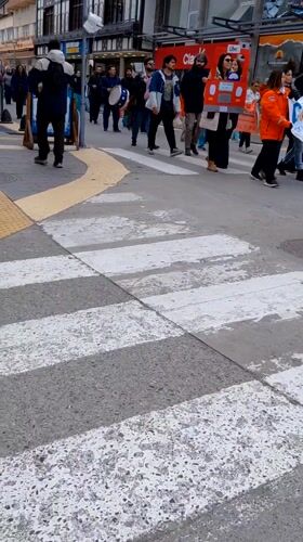 Pedestrians cross marked crosswalk in Ushuaia, Argentina