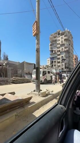 Street-level views of a busy Gaza neighborhood midmorning