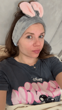 Woman in bunny ears relaxes on couch in Batumi