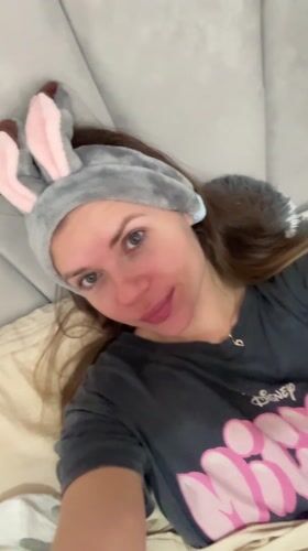Woman in bunny ears relaxes on couch in Batumi