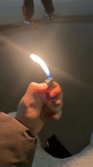 Person lights lighter in Sankt-Peterburg street gathering