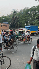 Rickshaw drivers and passengers observed on busy Dhaka street