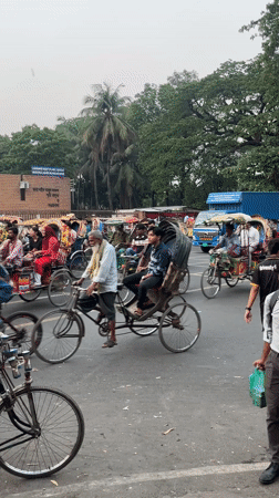 Rickshaw drivers and passengers observed on busy Dhaka street