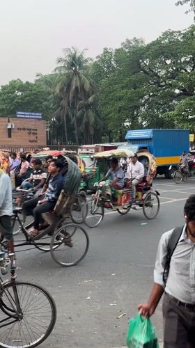 Rickshaw drivers and passengers observed on busy Dhaka street
