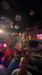 Performers dance atop bar at Kuta nightclub