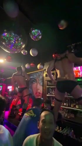 Performers dance atop bar at Kuta nightclub