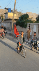 Political procession rolls through a South Asian city street