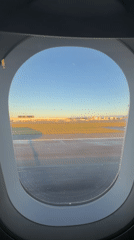 Passenger films golden hour airport view from plane window