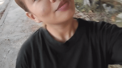 Woman Films Kissing Selfie Video on Porlamar Sidewalk