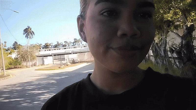 Woman Films Kissing Selfie Video on Porlamar Sidewalk