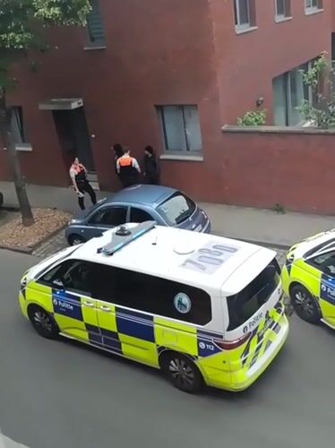 Police vehicles stationed on Leuven street during afternoon hours