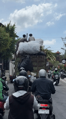 Waste collection truck with workers observed in Mengwi traffic