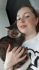 Woman and tabby cat share quiet moment in Russia