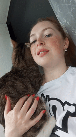 Woman and tabby cat share quiet moment in Russia