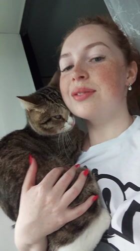 Woman and tabby cat share quiet moment in Russia
